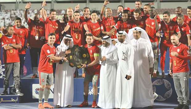 Al Duhail captain Youssef Msakni receives the winning shield from Qatar Football Association Vice-President Saoud Abdulaziz  al-Mohannadi. Qatar Stars League CEO Hani Taleb Ballan Duhail coach Djamel Belmadi are also seen. PICTURE: Noushad Thekkayil