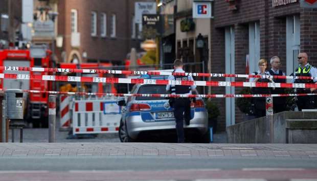 Police stands guard in a street near a place where a man drove a van into a group of people sitting outside a popular restaurant in the old city centre of Muenster