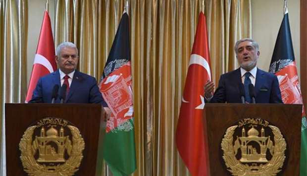 Afghan Chief Executive Officer Abdullah Abdullah gestures as he speaks next to Turkish Prime Minister Binali Yildirim during a press conference at Sapedar palace in Kabul on Sunday.