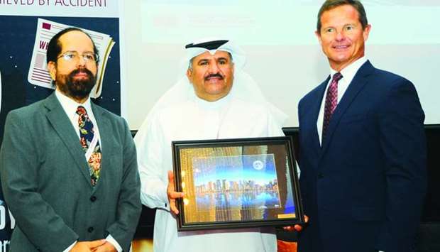 Goic assistant secretary general for Industrial Projects Sector Dr. Ali Al-Mulla receives a token from Texas A&M University at Qatar dean Dr. Cesar Malave and ConocoPhillips Qatar president J. Todd Creeger during the symposium. PICTURE: Shemeer Rasheed.