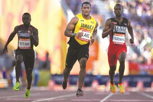 Jamaicau2019s Yohan Blake (centre) competes in the menu2019s 100m heats during the 2018 Commonwealth Games in Gold Coast, Australia, yesterday. (AFP)