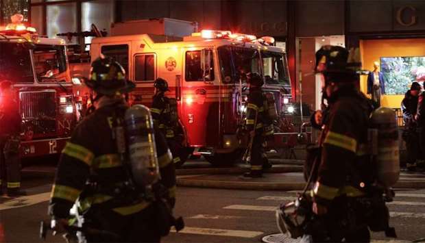 First responders assess the scene of a fire at Trump Tower in New York City.
