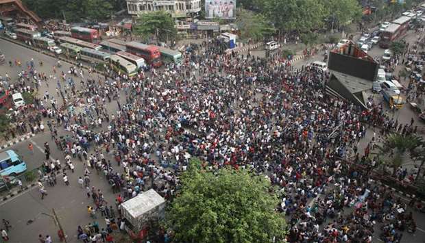 Bangladeshi university students block a road during a protest against the quota system used in government recruitment in Dhaka