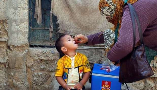 A Pakistani boy receives polio vaccine drops in Karachi on Monday.