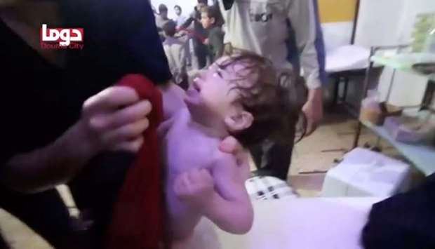 A child cries as they have their face wiped following alleged chemical weapons attack, in what is said to be Douma, Syria,  in this still image from video obtained by Reuters.