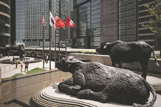 Bull statues displayed outside the Hong Kong Stock Exchange. The Hang Seng closed up 1.3% to 30,229.58 points yesterday.
