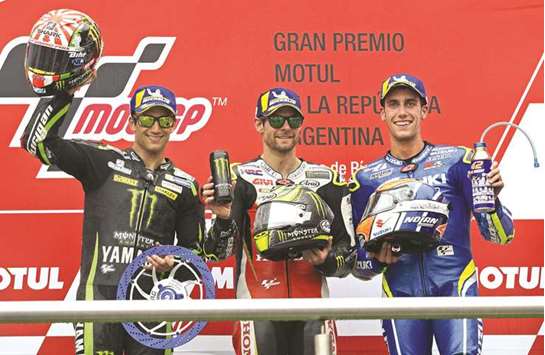 Honda biker Cal Crutchlow (centre) of Great Britain, Yamaha biker Johann Zarco (left) of France and Suzuki biker Alex Rins of Spain celebrate their first, second and third place respectively at the podium of the Argentina Grand Prix at Termas de Rio Hondo circuit, in Santiago del Estero, Argentina on Sunday. (AFP)
