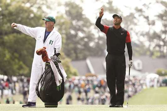 Tiger Woods of the United States waits on the first fairway with caddie Joe LaCava during the final round of the 2018 Masters Tournament on Sunday.