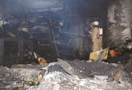 Fire-fighters douse the blaze at the four-storeyed factory in New Delhi yesterday.