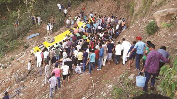 People search the mangled bus for survivors in Nurpur in Himachal Pradeshu2019s Kangra district yesterday.