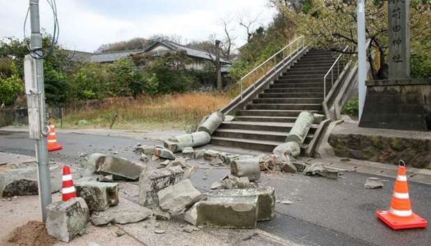 A stone torii gate damaged by an earthquake is seen at Karita Shrine in Ohda