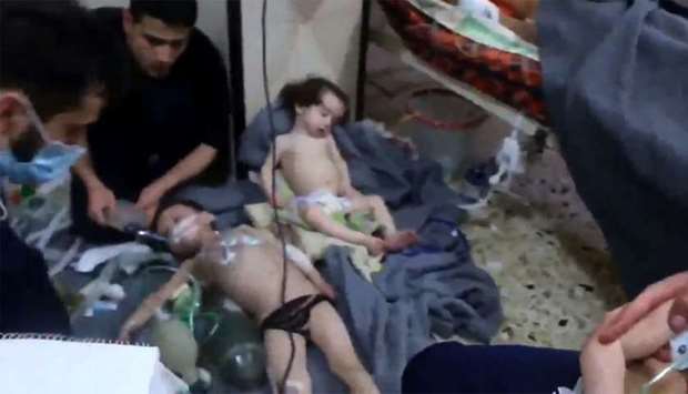 An image grab shows volunteers giving aid to children at a hospital following a reported chemical attack