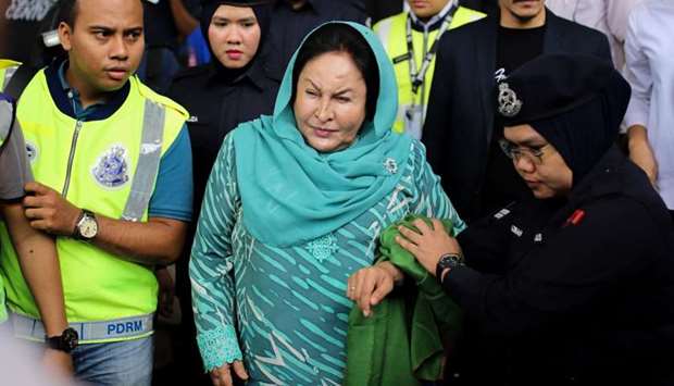 Former Malaysian prime minister Najib Razak's wife Rosmah Mansor (C) leaves the High Court after facing corruption charges in Kuala Lumpur