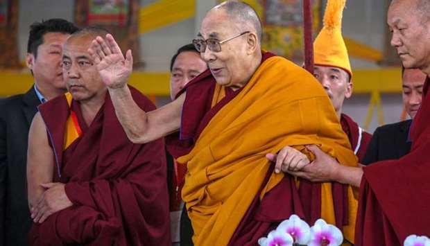 Tibetan spiritual leader the Dalai Lama (C) greets devotees at the closing ceremony of a teaching session at Kalachakra Ground in Bodhgaya. File photo: December 31, 2018