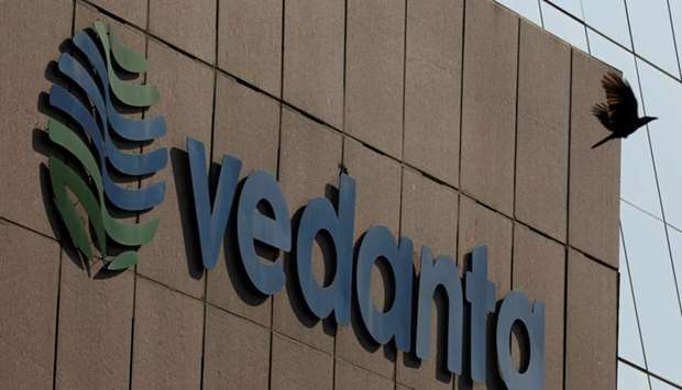 A bird flies past the logo of Vedanta installed on the facade of its headquarters in Mumbai, India