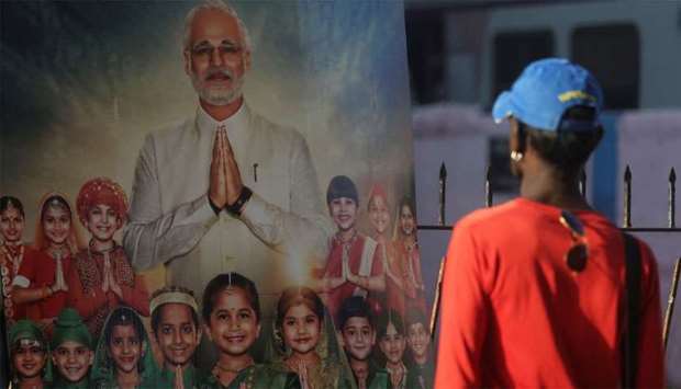 A man looks at the poster of upcoming film ,PM Narendra Modi,