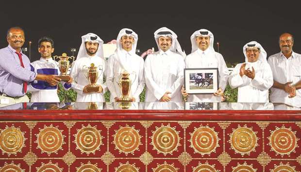 Winners pose during the trophy ceremony after Muraqabah won the Al Dibal Cup at the Qatar Racing and Equestrian Clubu2019s Al Rayyan Park yesterday. PICTURES: Juhaim