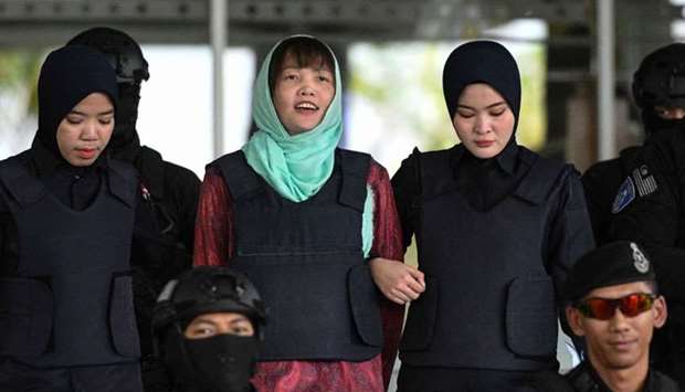 Vietnamese national Doan Thi Huong (C) is escorted by Malaysian police out of the High Court in Shah Alam