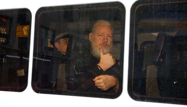 WikiLeaks founder Julian Assange is seen in a police van after was arrested by British police outside the Ecuadorian embassy in London