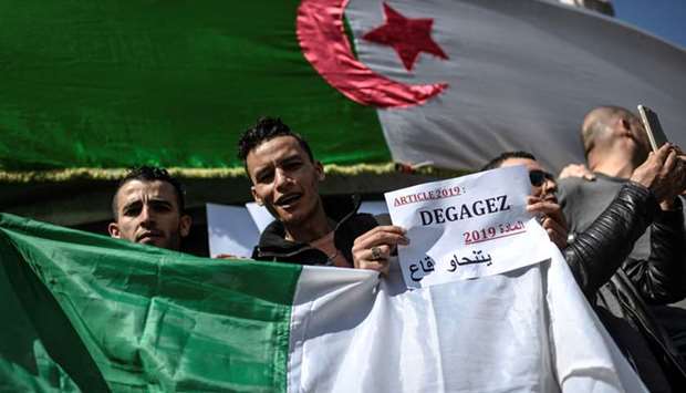 Protesters rally against the Algerian ruling party yesterday at the Place de la Republique in Paris.