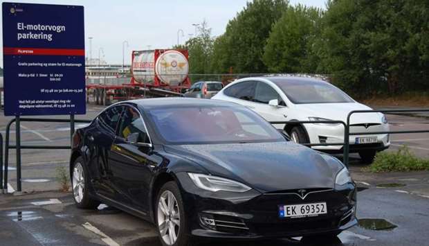 A file picture taken on July 31, 2018 shows a Model S (L) and Model X (R) electric cars of US car maker Tesla parked on a parking in Oslo, Norway