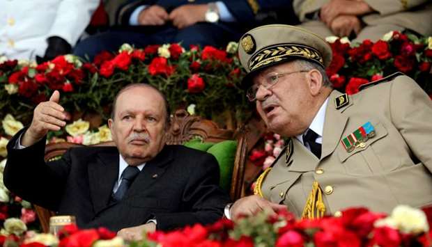 Algeria's President Abdelaziz Bouteflika gestures while talking with Army Chief of Staff General Ahmed Gaed Salah during a graduation ceremony of the 40th class of the trainee army officers at a Military Academy in Cherchell 90 km west of Algiers, Algeria June 27, 2012