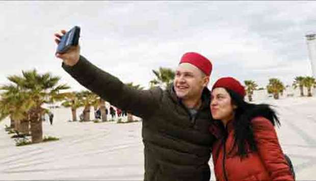 British tourists takes a selfie after arriving to Tunisia at the Enfidha Airport in Enfidha, Tunisia (file). The IMF, in its latest World Economic Outlook, projected the countryu2019s annual inflation of 6.8% in 2019 and 5.2% in 2020.