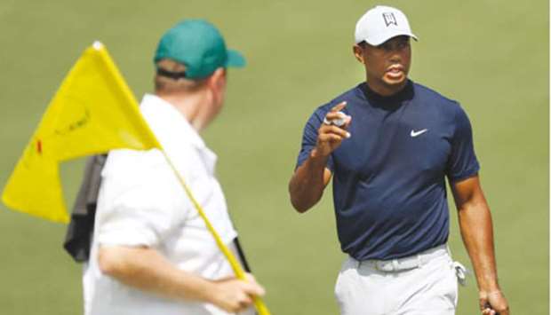 Tiger Woods of the US holds his ball after putting on the second green during first round play of the 2019 Masters golf tournament at Augusta National Golf Club in Augusta, Georgia, yesterday.