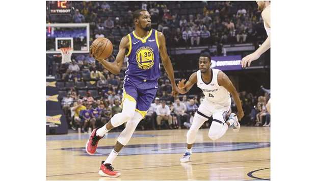 Golden State Warriors forward Kevin Durant passes the ball in front of Memphis Grizzlies forward Julian Washburn (right) in the first quarter of their NBA game at FedExForum on Wednsday. PICTURE: USA TODAY Sports