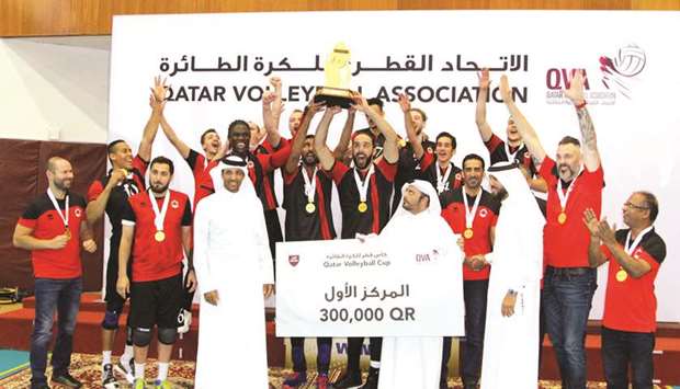 Al Rayyan players lift the Qatar Cup trophy in the presence of Qatar Volleyball Association (QVA) president Ali Ghanim al-Kuwari, QVA Board member Mohamed Salem al-Kuwari and other officials. PICTURES: Othman Khalid