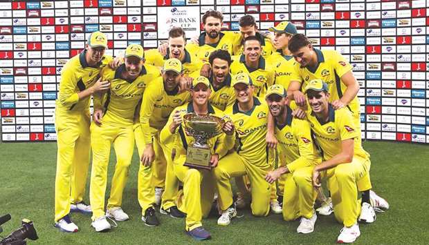Australian players pose with the trophy after winning the fifth ODI against Pakistan at Dubai International Stadium in Dubai on Sunday. (AFP)