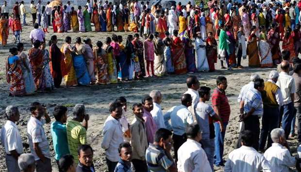 Voters line up to cast their votes outside a polling station during the first phase of general election in Alipurduar district in the eastern state of West Bengal