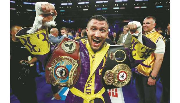 Vasyl Lomachenko celebrates after winning WBA & WBO world lightweight titles by defeating Anthony Crolla at the Staples Center in Los Angeles. (Reuters)