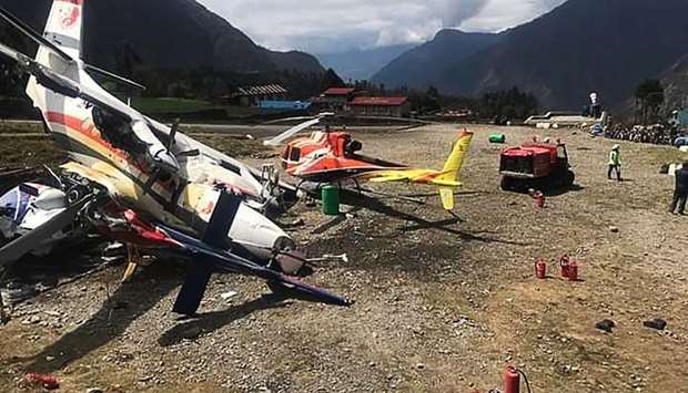 A Summit Air Let L-410 Turbolet aircraft bound for Kathmandu is seen after it hit two helicopters during take off at Lukla airport, the main gateway to the Everest region.