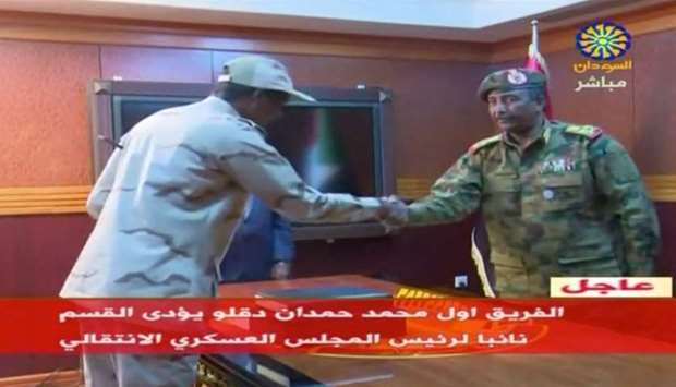 Sudan's General Abdelfattah Mohamed Hamdan Dagalo, known as ,Hemeti,, head of the Rapid Support Forces, is sworn-in as the appointed deputy of Sudan's transitional military council, standing before the head of transitional council, Lieutenant General Abdel Fattah Al-Burhan Abdelrahman (R) in Khartoum