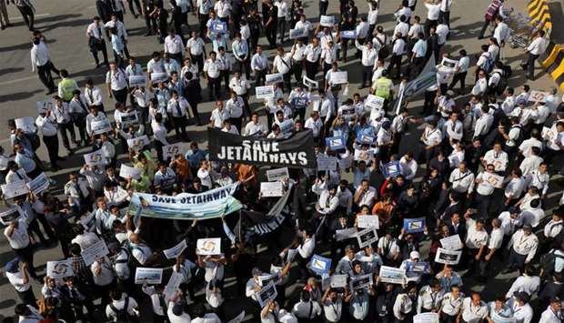 Jet Airways employees hold placards and banners during a protest demanding to ,save Jet Airways, at the Indira Gandhi International Airport in New Delhi