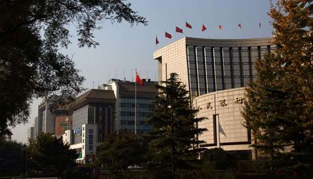 The People's Bank of China headquarters (right) stands in the financial district of Beijing.
