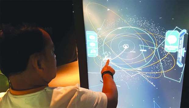 A visitors tries some of the interactive features of Al Thuraya Planetarium. PICTURE: Joey Aguilar
