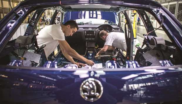 Workers assemble the interior of a Skoda automobile on the production line at the Skoda Auto manufacturing plant in Mlada Boleslav, Czech Republic (file). Controlled by Volkswagen since 1991, Skoda exports some 80,000 cars to Britain a year, almost 10% of its annual output.