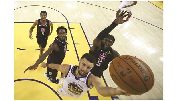 Golden State Warriors guard Stephen Curry shoots the basketball against LA Clippers forward Montrezl Harrell (No 5) during the first-half in game one of the first round of the 2019 NBA Playoffs at Oracle Arena. PICTURE: USA TODAY Sports