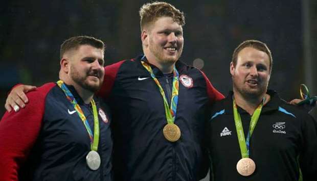 Olympic gold medallist Ryan Crouser (C), silver medallist Joe Kovacs (L) and bronze medallist Tom Walsh in Rio in 2018.