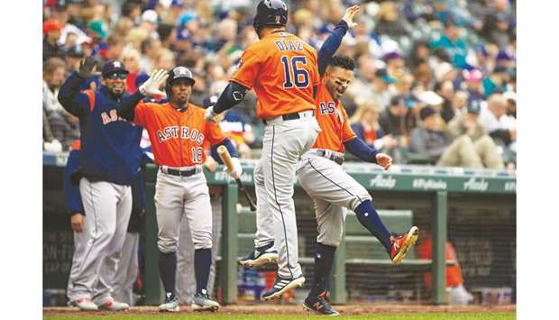 Houston Astrosu2019 Aledmys Diaz (centre) celebrates with Jose Altuve (right) after hitting a home run in the seventh inning against the Seattle Mariners. PICTURE: USA TODAY Sports
