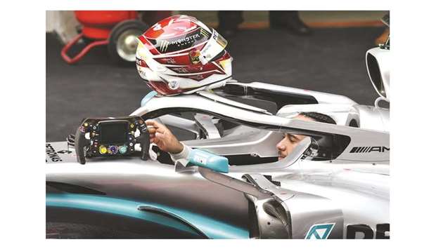 Mercedesu2019 British driver Lewis Hamilton prepares to get out of his car after arriving in the pits following his victory in the Formula One Chinese Grand Prix in Shanghai. (AFP)