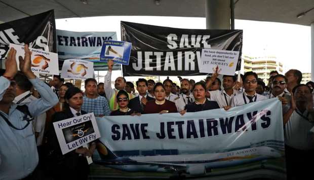 Jet Airways employees hold placards and banners during a protest at the Indira Gandhi International Airport in New Delhi on April 13