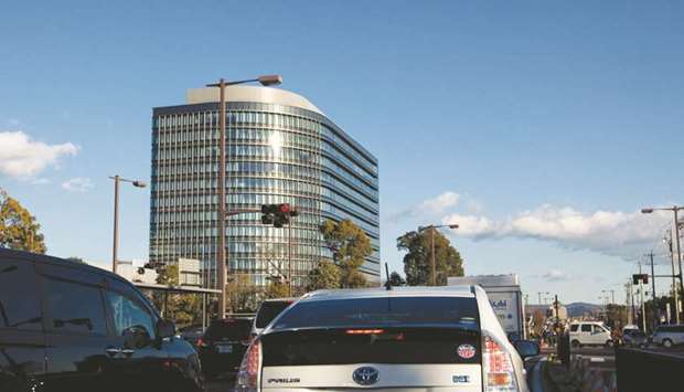 A Toyota Motor Corp Prius hybrid vehicle drives past the companyu2019s headquarters in Toyota City (file). Toyota has agreed to sell electric car technology to Singulato, its first deal with a Chinese electric vehicle startup, allowing the fledgling firm to speed up development of a planned mini EV.