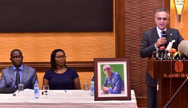 Tom and Esther Kabau, listen to their attoney Nomaan Husain (R) speaking at a press conference, as he announces that the family is to file a law suit against US plane manufacturers Boeing over the wrongful death of their kin, George Kabau, (portrait) in last month's plane crash involving Ethiopian Airlines flight