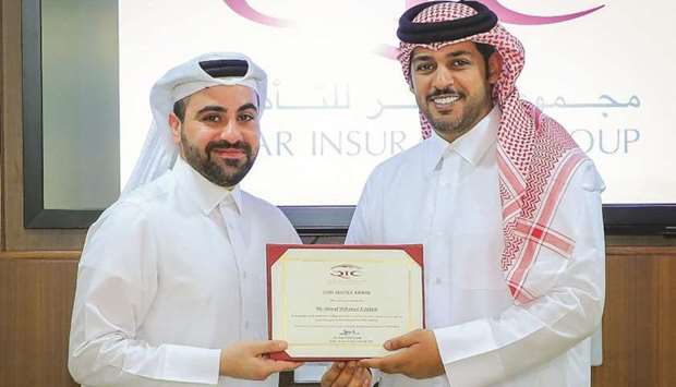 Ahmad Mohamed Zebeib receiving his certificate from al-Mannai.