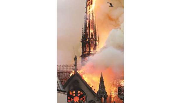 Smoke billows as fire engulfs the spire of the Notre-Dame Cathedral in Paris.