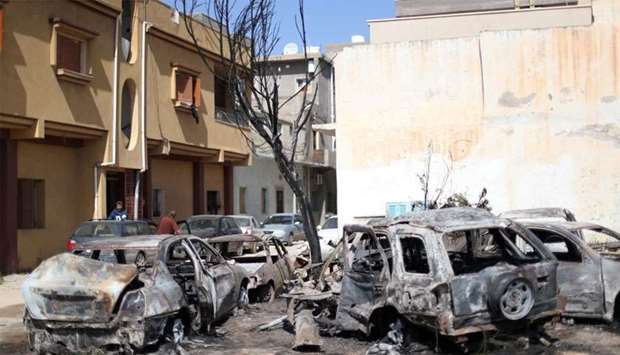 Vehicles damaged by an overnight shelling are seen in Abu Salim district in Tripoli, Libya