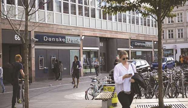Customers use an automated teller machine (ATM) outside a Danske Bank A/S bank branch in central Copenhagen, Denmark, in this Sept 19, 2018 file photo. Danske Bank was allegedly at the centre of a major European money laundering scandal with as much as $225bn flowing through a tiny unit in Estonia.